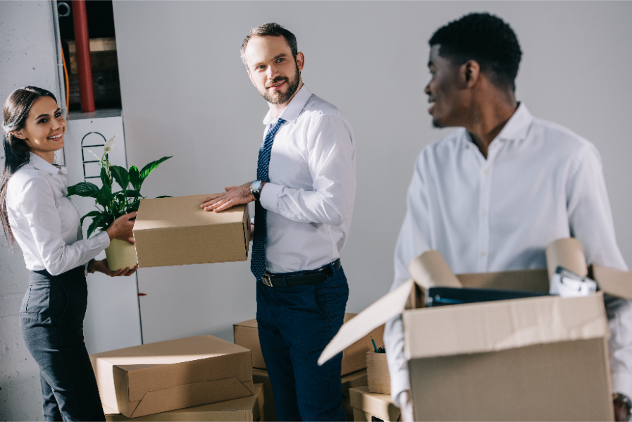 Office workers packing boxes getting ready for a commercial move